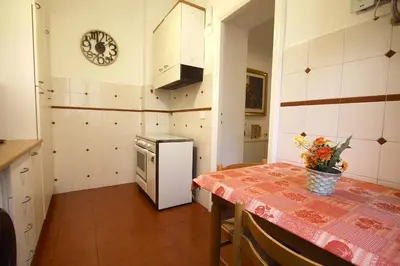 a kitchen with a table and a small refrigerator at La Finestra sulla Basilica in Rome