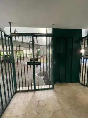 an open gate with a green door in a building at Olimpic Sunny room in Rome