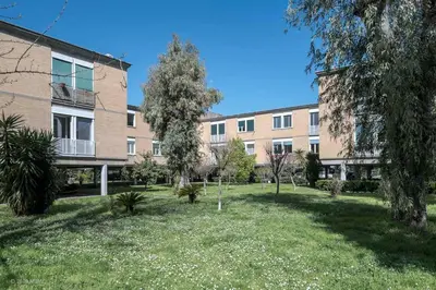 an apartment building with a lawn in front of it at Olimpic Sunny room in Rome