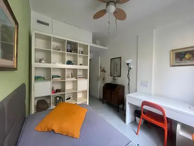 a bedroom with a bed and a desk and a chair at Olimpic Sunny room in Rome