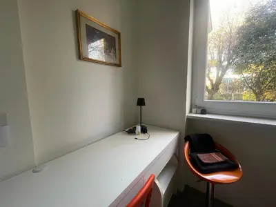 a white desk with a chair next to a window at Olimpic Sunny room in Rome