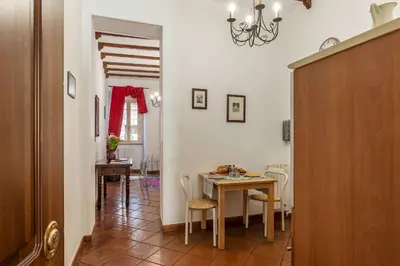a kitchen and dining room with a table and chairs at Casa Fiori - WelcomeToRhome in Rome