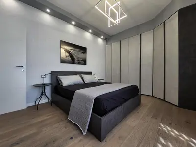 a bedroom with a large bed and a chandelier at Patrica house in Rome
