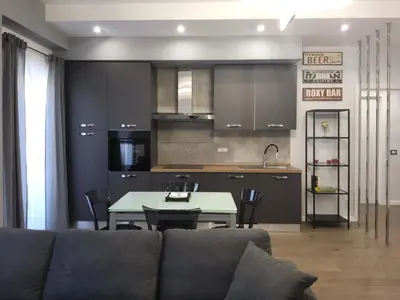 a living room with a couch and a table and a kitchen at Patrica house in Rome