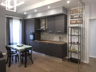 a kitchen with a table and a dining room at Patrica house in Rome