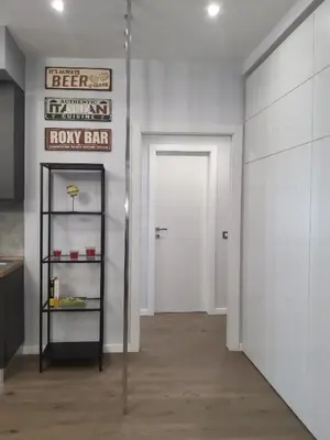 a white hallway with a white door and a sign at Patrica house in Rome