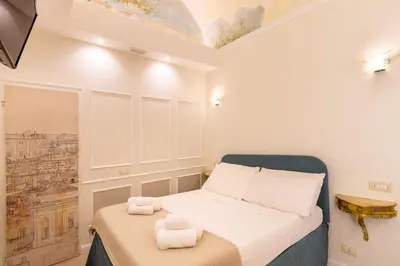 a small bedroom with a bed with towels on it at NOH Forum Patio in Rome