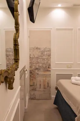 a bedroom with a drawing of a city on the wall at NOH Forum Patio in Rome