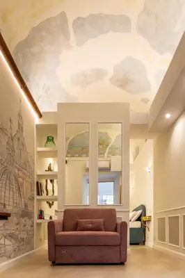 a living room with a couch and a painting on the ceiling at NOH Forum Patio in Rome