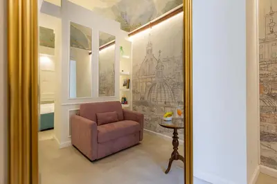 a room with a chair and a mirror at NOH Forum Patio in Rome