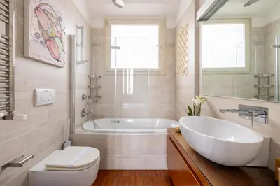 a bathroom with a tub and a toilet and a sink at Nostromondo BIANCAMANO ATTIC - Stylish penthouse with private terrace- San Giovanni in Rome