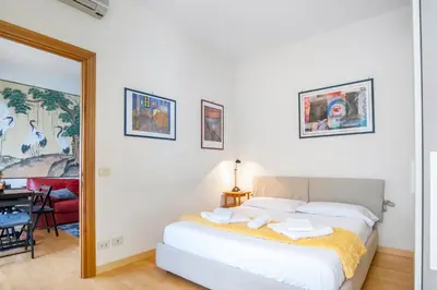 a bedroom with a bed and a table and a mirror at Boutique Caravaggio in Rome