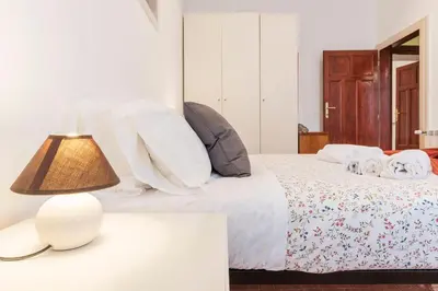 a bedroom with a bed with a lamp on a table at Casa di Vigo - WelcomeToRhome in Rome