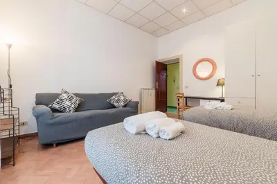 a living room with two beds and a couch at Casa di Vigo - WelcomeToRhome in Rome