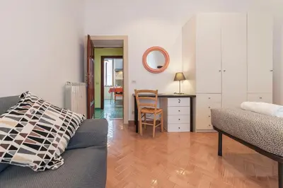 a living room with a couch and a dining room at Casa di Vigo - WelcomeToRhome in Rome