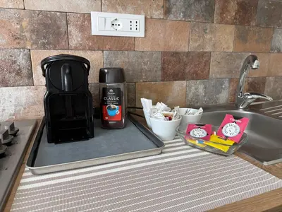 a coffee maker sitting on a counter next to a sink at Sunflower House in Rome