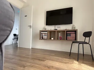 a living room with a flat screen tv on a wall at Sunflower House in Rome