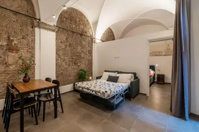 a bedroom with a bed and a table in a room at Casa Giulia - WelcomeToRhome in Rome