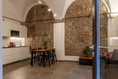 a kitchen and dining room with a table and chairs at Casa Giulia - WelcomeToRhome in Rome