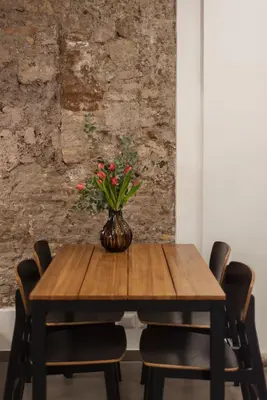 a wooden table with a vase of flowers on it at Casa Giulia - WelcomeToRhome in Rome