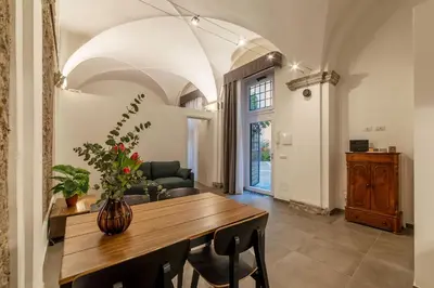 a dining room with a table with a vase on it at Casa Giulia - WelcomeToRhome in Rome