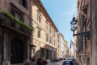 a city street with buildings and cars parked on the street at Casa Giulia - WelcomeToRhome in Rome