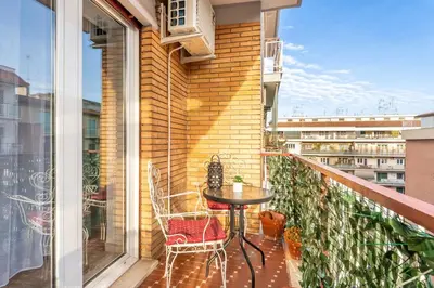 a balcony with a table and chairs on a balcony at 7th Floor Terrace Stay - San Giovanni & Colosseum in Rome