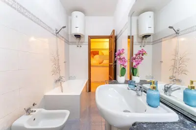 a bathroom with two sinks and a tub at 7th Floor Terrace Stay - San Giovanni & Colosseum in Rome