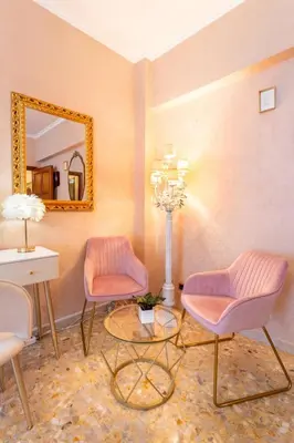 a room with two chairs and a table and a mirror at 7th Floor Terrace Stay - San Giovanni & Colosseum in Rome