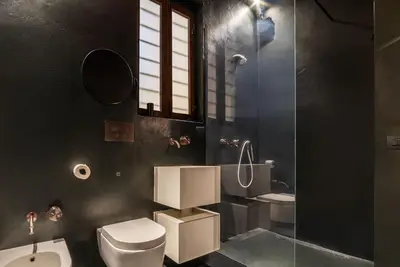 a bathroom with a toilet and a shower and a sink at GuestHost - Vintage-Modern Apartment Trastevere in Rome