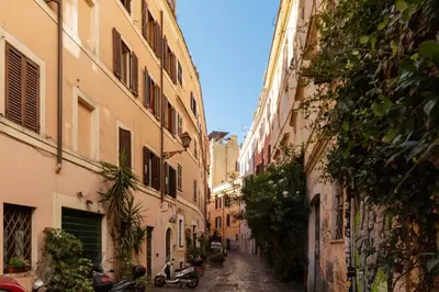 an alley way between two buildings in a city at GuestHost - Vintage-Modern Apartment Trastevere in Rome