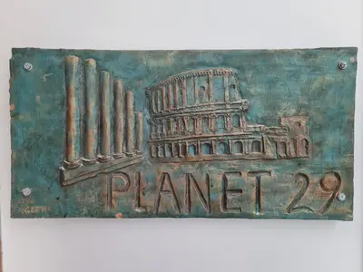 a sign with a picture of the coliseum at Guest House Planet 29 in Rome