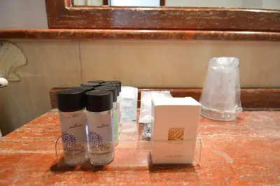 a table with bottles ofodorizers and a box on it at Guest House Planet 29 in Rome