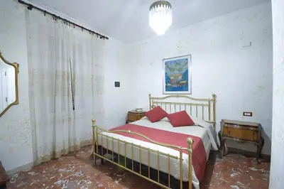 a bedroom with a bed with red pillows at Guest House Planet 29 in Rome