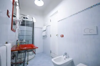 a white bathroom with a sink and a toilet at Guest House Planet 29 in Rome