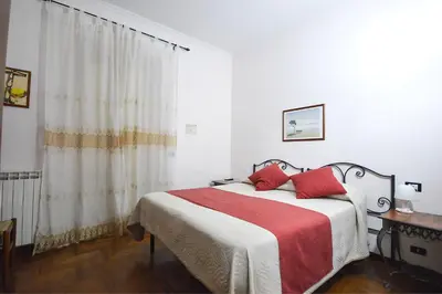 a bedroom with a bed with red pillows at Guest House Planet 29 in Rome