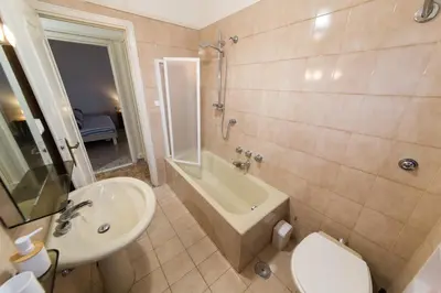 a bathroom with a sink and a tub and a toilet at raffaele affittacamere guesthouse in Rome