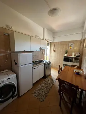 a kitchen with a table and a stove top oven at raffaele affittacamere guesthouse in Rome