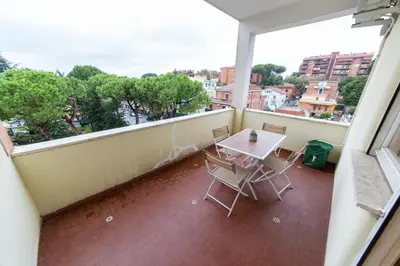 a balcony with a table and chairs and a view at raffaele affittacamere guesthouse in Rome