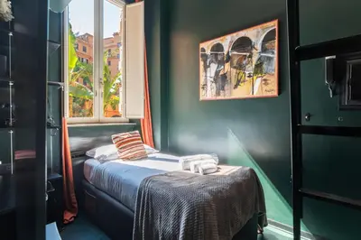 a small room with a bed and a window at GuestHost - San Pietro Studio Apartment Roma in Rome