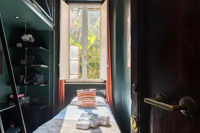 a bedroom with a window and a bed with a pillow at GuestHost - San Pietro Studio Apartment Roma in Rome