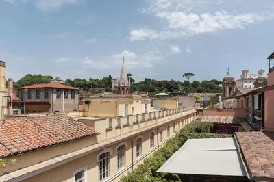 a view of a city from the roofs of buildings at Terrazza di Flamy - WelcomeToRhome in Rome