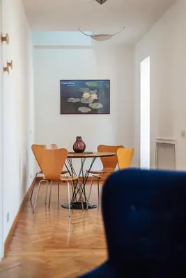 a living room with a table and chairs at Terrazza di Flamy - WelcomeToRhome in Rome