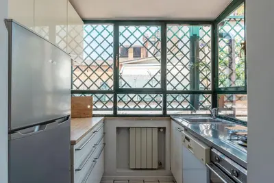 a kitchen with a sink and a window at Terrazza di Flamy - WelcomeToRhome in Rome