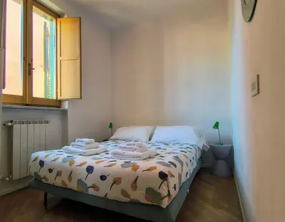a bedroom with a bed with towels on it at Terrazza di Flamy - WelcomeToRhome in Rome