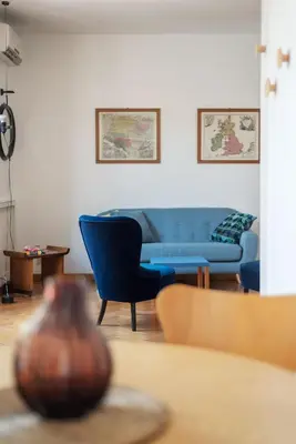 a living room with a blue couch and a table at Terrazza di Flamy - WelcomeToRhome in Rome