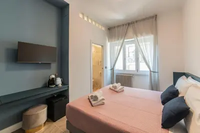 a bedroom with a bed with two towels on it at Victoria Rooms in Rome