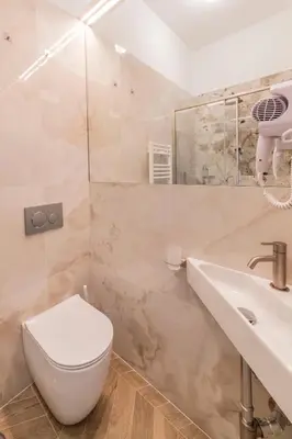 a bathroom with a toilet and a sink at Victoria Rooms in Rome