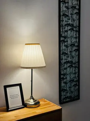 a lamp sitting on a table next to a picture at Little Colosseum Gem in Rome