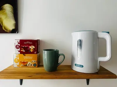 a wooden shelf with a coffee maker and a mug at Little Colosseum Gem in Rome